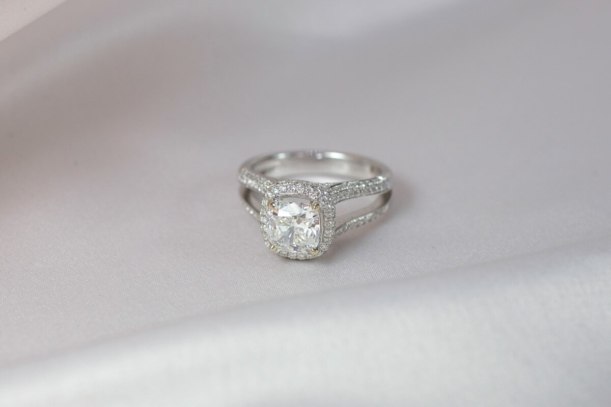 Cushion cut ring with halo and split shank